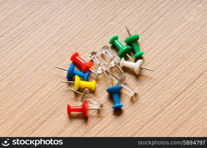 Many colourful office pins on the background