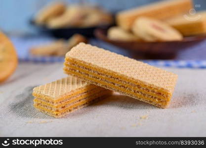 Many cookies are placed on the fabric and then placed on a wooden table.