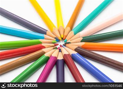 Many different color pencils lying isolated on white background in a circle