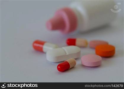 Many different colors pills and tablets isolated on white background,shallow depth of field