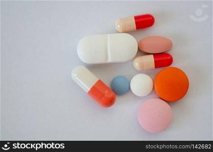 Many different colors pills and tablets isolated on white background,shallow depth of field