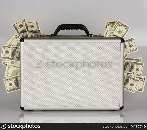 many dollar bills in a briefcase. crime in the economy