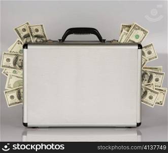 many dollar bills in a briefcase. crime in the economy