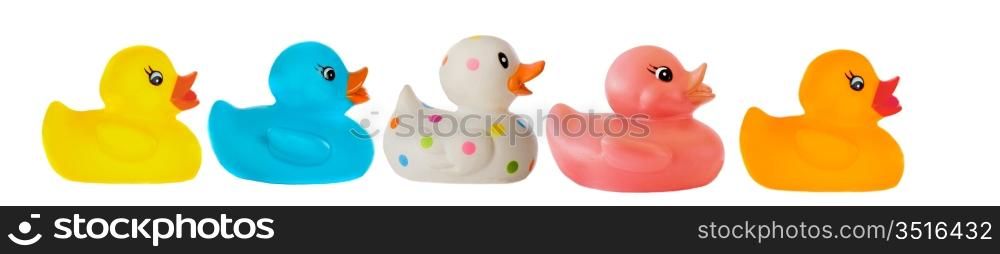 Many ducks toy of different colors on a over white background