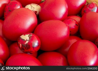 Many Easter red colored eggs in the basket on the table. Top view