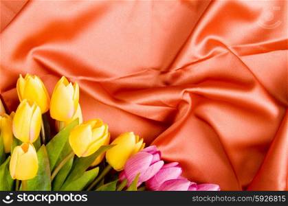 Many flowers on the red satin background