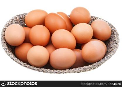 many fresh chicken eggs in wicker basket isolated on white background