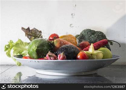 many fresh vegetables falling in water,healthy food