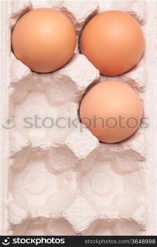 many fresh yellow chicken eggs in container