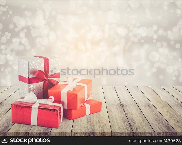 many gift box with ribbon on wood table top bokeh white background - using for christmas and new year or holiday other - celebration concept.
