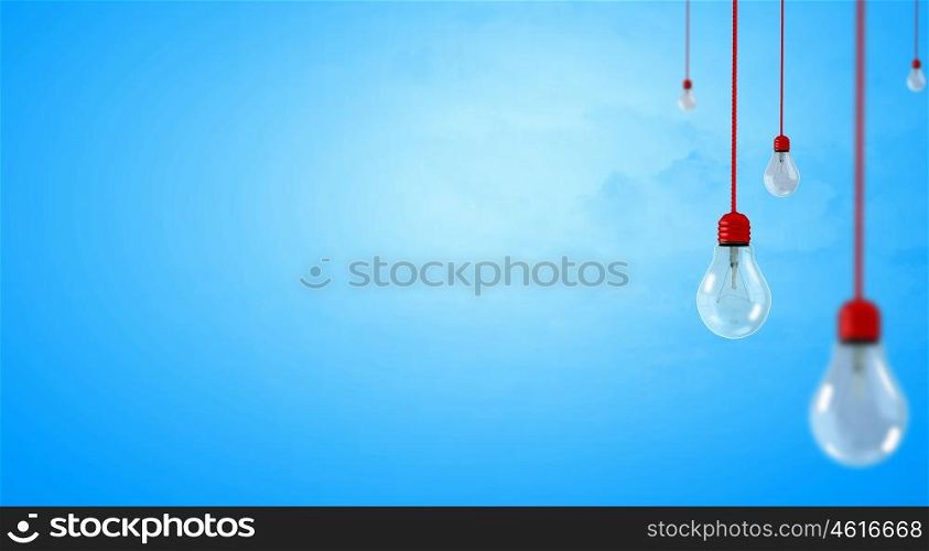 Many glass light bulbs hanging from above. Hanging bulbs