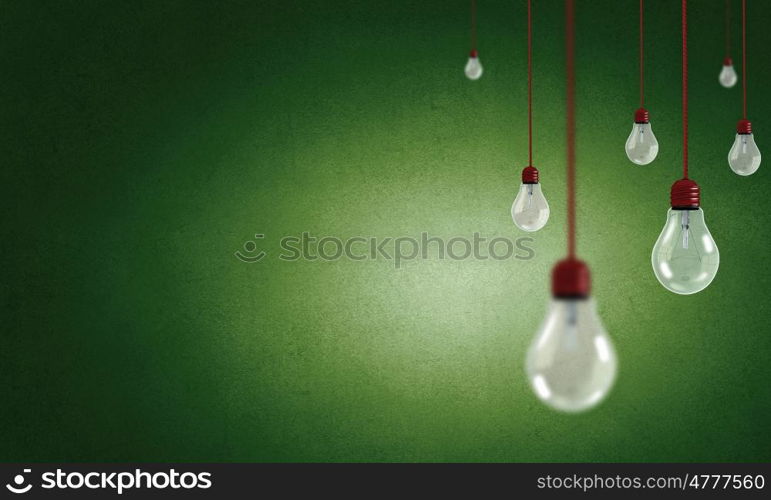 Many glass light bulbs hanging from above. Hanging bulbs