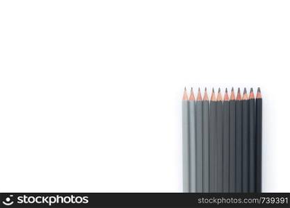 Many gray pencils on a white background. Top view. Row of gray pencils on a white background. Top view. Copyspace