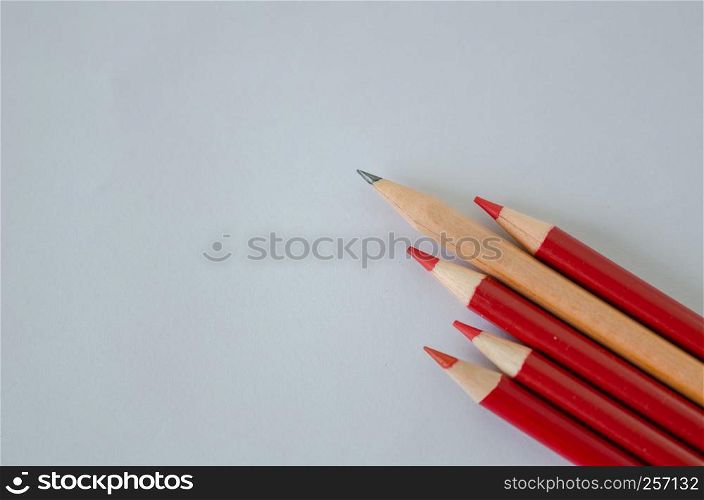 Many group of red pencils but yellow color pencil standing out from crowd of plenty identical, leadership, independence, uniqueness, initiative, initiative, think different, business success concept isolated