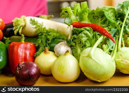 Many healthy colorful vegetables on kitchen table. Dieting, vegetarian local fresh food, natural source of vitamins.. Many healthy colorful vegetables