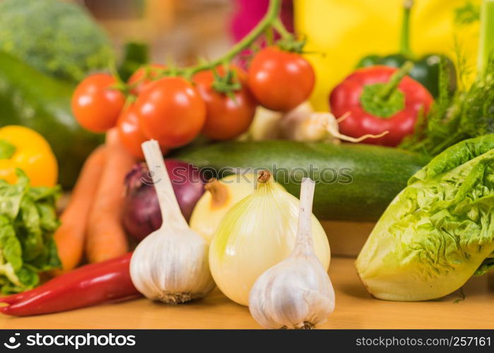 Many healthy colorful vegetables on kitchen table. Dieting, vegetarian local fresh food, natural source of vitamins.. Many healthy colorful vegetables