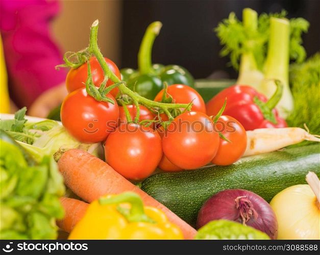 Many healthy colorful vegetables on kitchen table. Dieting, vegetarian local fresh food, natural source of vitamins.. Many healthy colorful vegetables