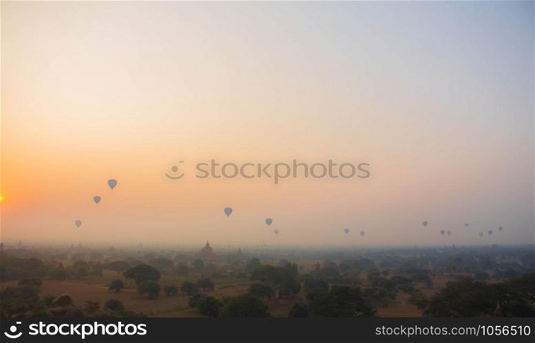Many hot air balloons flying over the temples