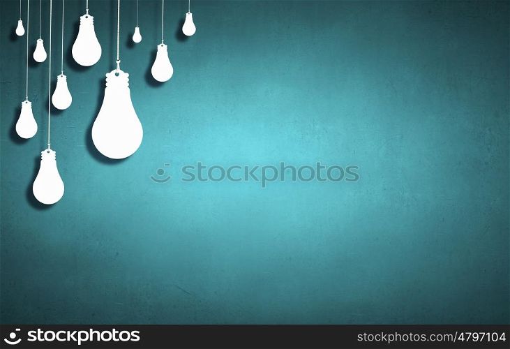 Many light bulbs on color background hanging from above. Hanging bulbs