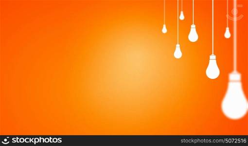 Many light bulbs on color background hanging from above. Hanging bulbs