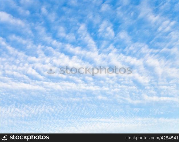 many light white clouds in blue sky in October