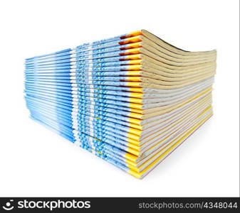 Many magazines stacked in a pile isolated on white