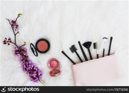 many makeup brushes out pink bag flower twig compact face powder soft white fur. High resolution photo. many makeup brushes out pink bag flower twig compact face powder soft white fur. High quality photo