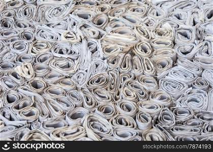 Many newspapers. background of lots of rolls of newspapers