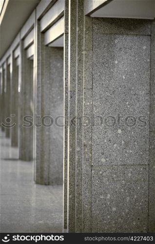 Many of columns coated with gray granite. Column lined with granite