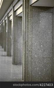 Many of columns coated with gray granite. Column lined with granite