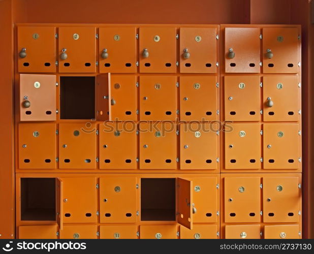 Many orange mailboxes. Some of them opened