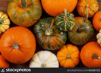 Many orange pumpkins on wooden background , Halloween concept. Pumpkins on wooden background