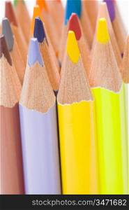 Many pencils of different colors on a over white background