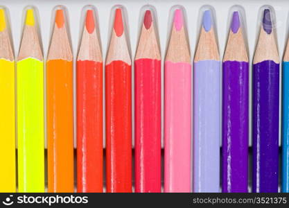 Many pencils of different colors on the plastic cover