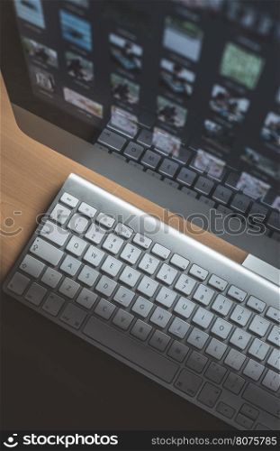 Many pictures on computer monitor. Keyboard
