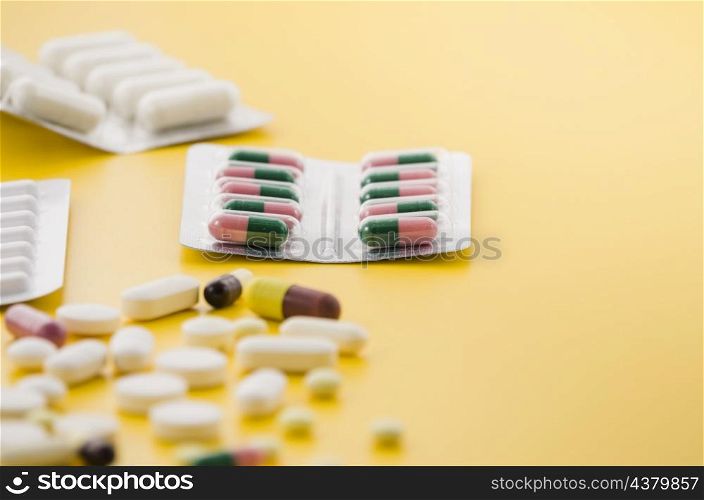 many pill blister pack yellow background