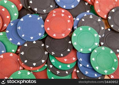 Many poker chips of four different colors
