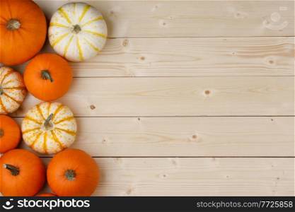 Many pumpkin top border over a rustic wood background. Pumpkin border over rustic wood