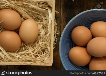 Many raw eggs in a wooden background