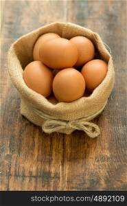 Many raw eggs in a wooden background