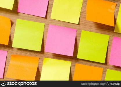 Many reminder notes on the wooden background