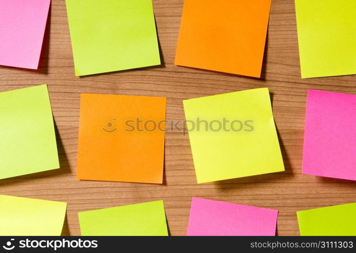 Many reminder notes on the wooden background