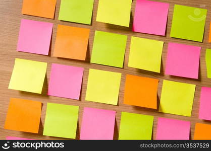 Many reminder notes on the wooden background