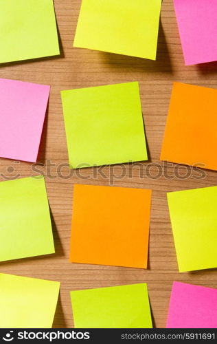 Many reminder notes on the wooden background