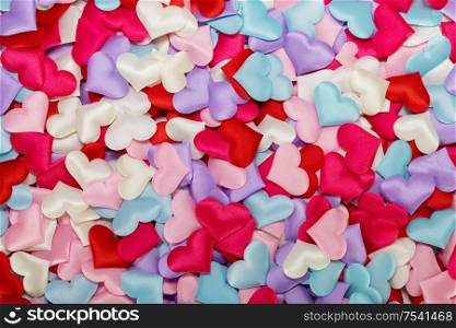 Many satin colorful hearts background. St Valentines Day. Congratulations card on Valentine Day. Many satin hearts background