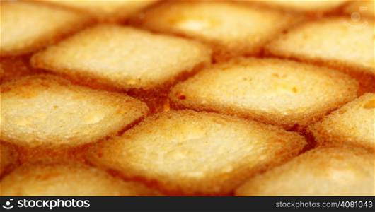 Many small dried rusks bread loaf toast biscuits as texture background. Diet food healthy nutrition.
