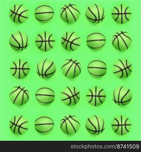 Many small green balls for basketball sport game lies on texture background of fashion pastel green color paper in minimal concept.. Many small green balls for basketball sport game lies on texture background