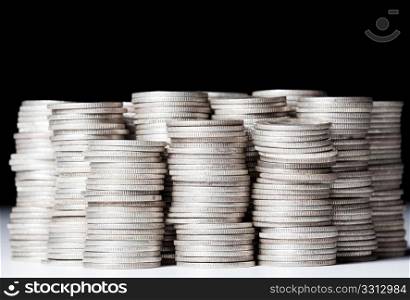 Many stacks of old silver dimes face on to camera