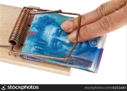 many swiss francs banknotes in mouse trap