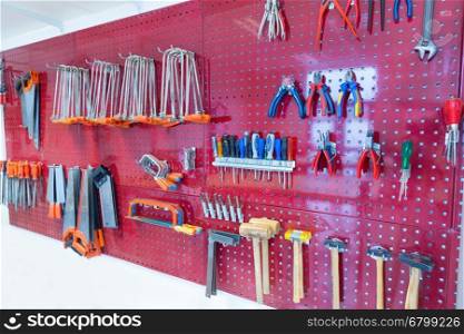 Many tools hanging at pegboard in classroom of school